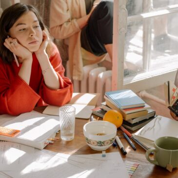 woman in red long sleeve shirt sitting on chair